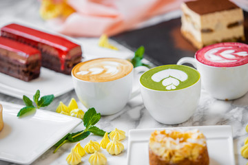 delicious composition of latte tea with cakes