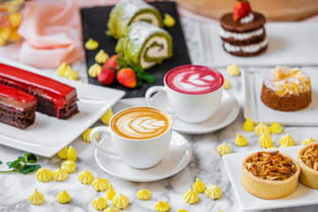 Fototapeta na wymiar delicious composition of latte tea with cakes