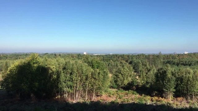 View across woodland and forest to the Bracknell Town Centre in Berkshire England. Pan from left to right.