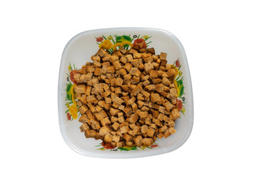 a top view of a bowl of crackers on a white background