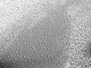 Water drops on glass. Rain droplets on glass background