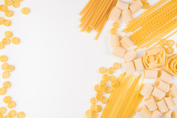 An overhead photo of different types of pasta, including spaghetti, penne, fusilli, and others,...