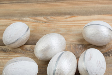 Happy Easter. Painted eggs on wooden table. Top view.