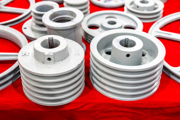 iron casting industrial parts pulley for transmission power to automotive engine pump or blower casting by green sand or shell mold process on red table