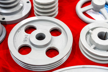 iron casting industrial parts pulley for transmission power to automotive engine pump or blower casting by green sand or shell mold process on red table