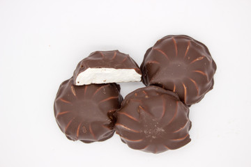Marshmallows in chocolate. The isolated image on the white background.
