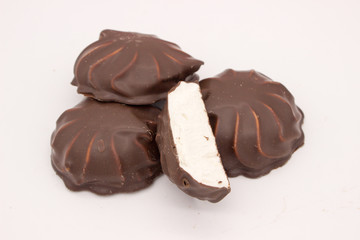 Marshmallows in chocolate. The isolated image on the white background.