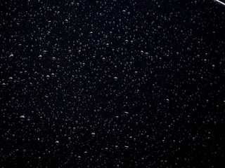 Water drops on glass. Rain droplets on glass background