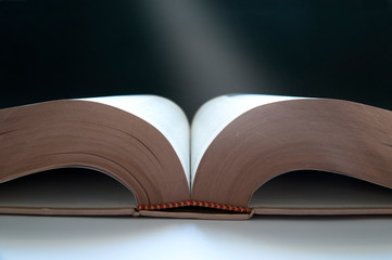 a falling beam of light on an open book