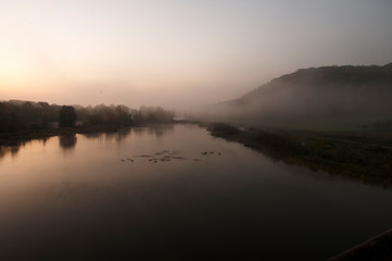 Fototapeta na wymiar The river Neckar at an early cold morning with fog over the water