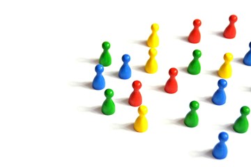 Game figures from a board game in different colors stand on a white background and throw all the...