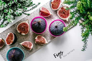 Obraz na płótnie Canvas Figs. Food Photo. Fresh sliced ​​fruit on old texture board. Summer composition with figs. View from above. Copy space