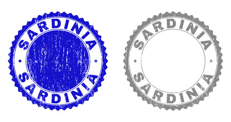 Grunge SARDINIA stamp seals isolated on a white background. Rosette seals with distress texture in blue and grey colors. Vector rubber stamp imitation of SARDINIA text inside round rosette.