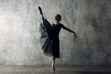 Ballerina female. Young beautiful woman ballet dancer, dressed in professional outfit, pointe shoes...