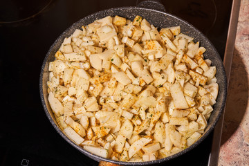 Potatoes with spices fried in a pan