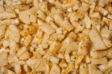 Potatoes with spices fried in a pan. Macro