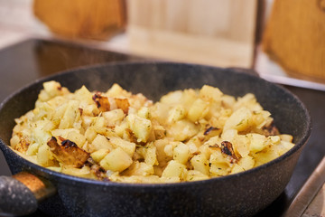 Potatoes with spices fried in a pan