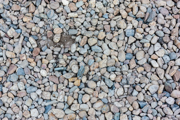 Natural colorful pebble (stones) background texture with copy space.