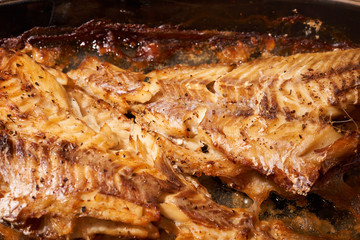 Baked fish with onions and spices. Macro mode