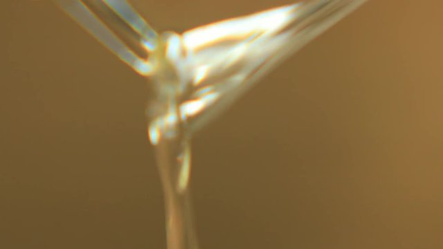 Close up of the sustainable macauba palm oil, pouring out of a machine.