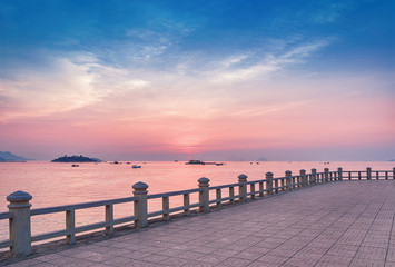 Fototapeta na wymiar Sunrise over the sea. View from the embankment of Nha Trang