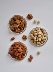 mixed nuts in a bowl isolated on white background