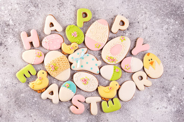 Happy Easter colorful lettering Happy Easter of ginger biscuits and cookies bunny on stone background.