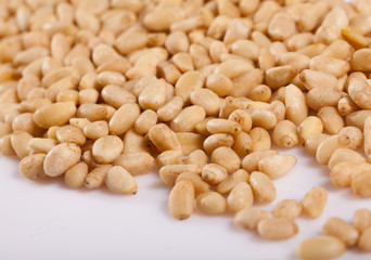 Pile of delicious pine nuts on a white surface