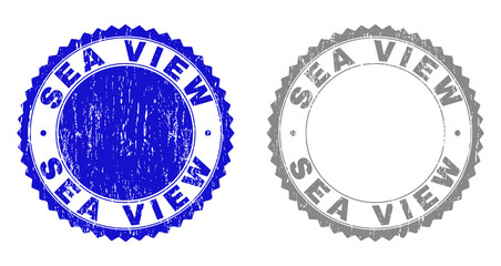 Grunge SEA VIEW stamp seals isolated on a white background. Rosette seals with grunge texture in blue and gray colors. Vector rubber stamp imitation of SEA VIEW tag inside round rosette.