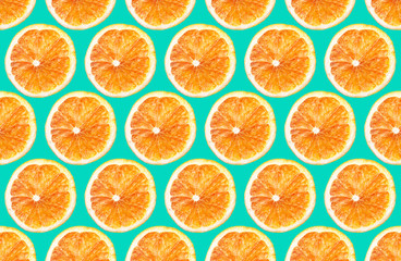 Cut orange fruit sections. Round slices pattern design isolated on blue background. 
