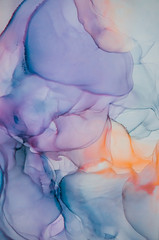Alcohol ink wash texture on white paper background. Liquid paint flow. Transparent ethereal effect. Closeup of the painting. Highly-textured colorful abstract painting background.