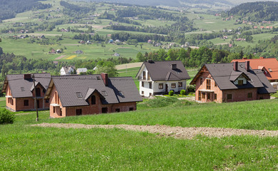 Fototapeta na wymiar A new housing estate under construction. A housing estate for new homes in the periphery. mountainous terrain, Building home