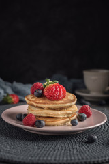 Delicious american pancakes with berries. Vertical. Copyspace