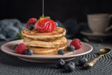 Delicious american pancakes with berries and syrup. Horizontal. Closeup