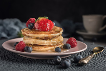 Delicious american pancakes with berries and syrup. Horizontal. Closeup
