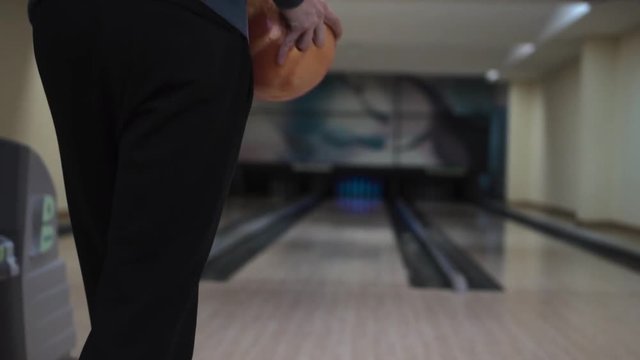 Guy throws a bowling ball