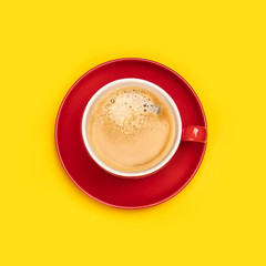 Red cup of coffee on yellow background