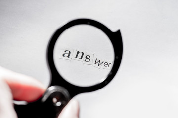 get an answer.Answer to the question.Word answer composed of paper letters through a magnifying glass