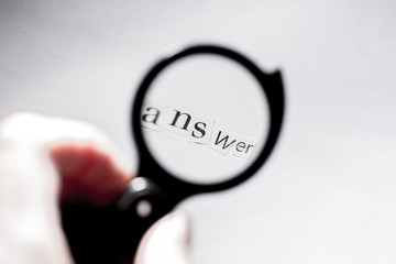 get an answer.Answer to the question.Word answer composed of paper letters through a magnifying glass