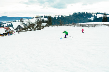 Skier in professional equipment rushes from the mountain in the village of western Ukraine