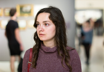Fototapeta premium Woman visiting museum and thinking indoors