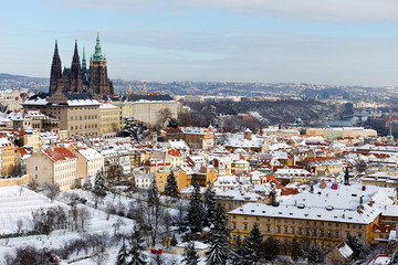 Snowy Prague City with gothic Castle from Hill Petrin in the sunny Day, Czech republic