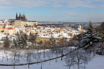 Snowy Prague City with gothic Castle from Hill Petrin in the sunny Day, Czech republic