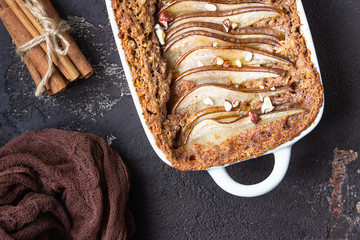 Diet crumble with oatmeal, cinnamon and pears decorated with hazelnut and honey in a frying pan for...