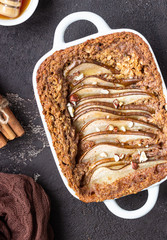 Diet crumble with oatmeal, cinnamon and pears decorated with hazelnut and honey in a frying pan for...