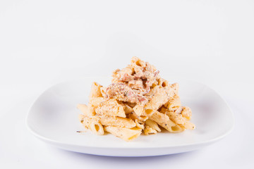 Pasta - penne with cream sauce with bacon on a plate