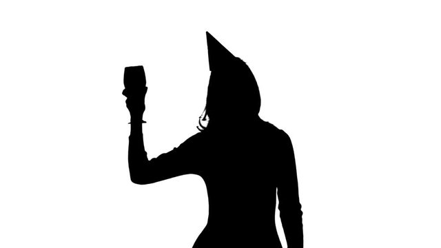 Girl in cap dances at a party with a glass in hand. White background. Silhouette