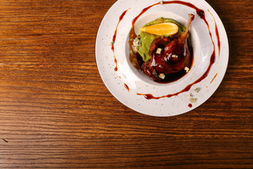 Beijing duck leg with orange and  dressed with caramel