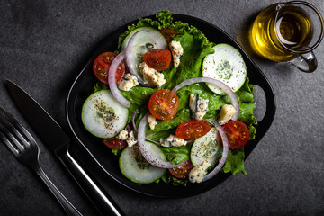 Fresh green salad with blue cheese, onions and cherry tomatoes
