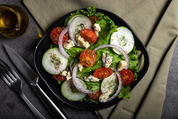 Fresh green salad with blue cheese, onions and cherry tomatoes